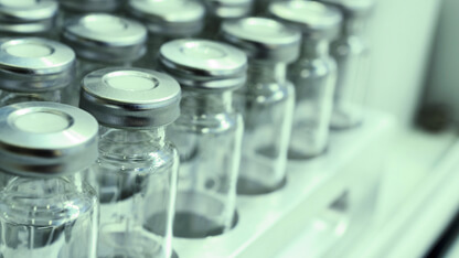 Pharmaceutical glass vials with stoppers used in stability testing to ensure packaging safety through sustainable analytical methods.
